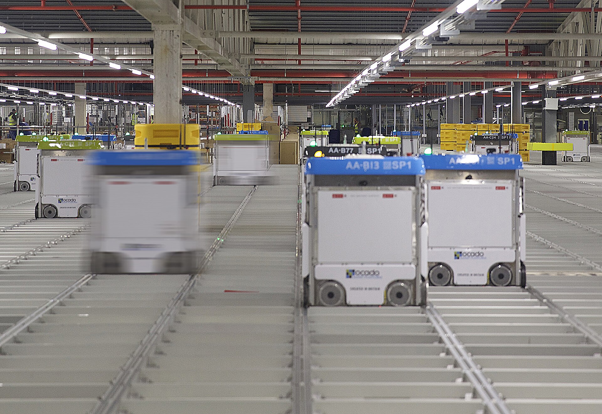 Automated e-commerce warehouse: a fleet of robots sorts and routes orders, mirroring the fulfillment centers pushed to their limit during the Double 11 peak